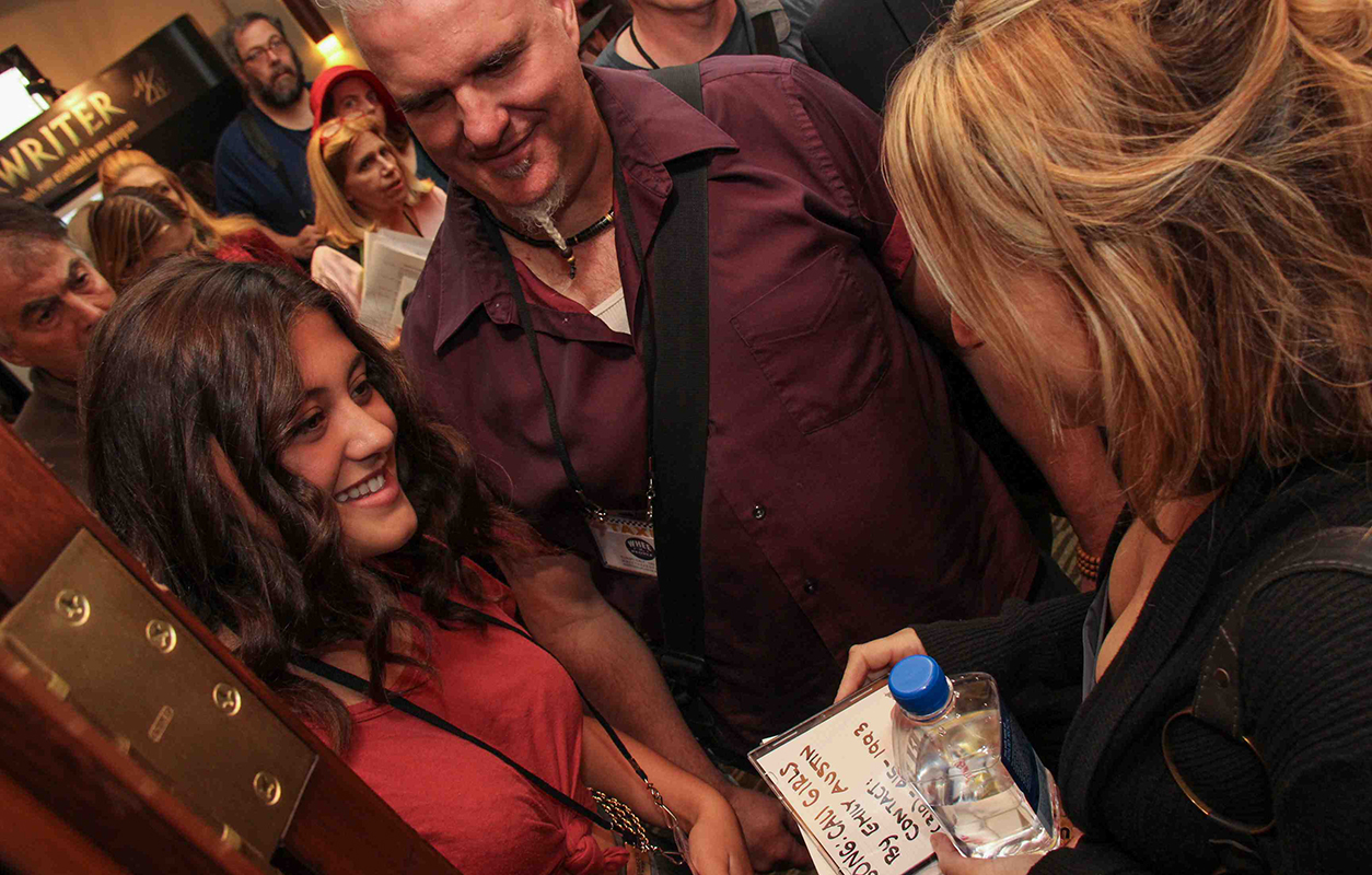 Hollywood Film Music Supervisor Beth Amy Rosenblatt takes CDs from a member after the amazing Music Supervisor Listening and Q&A Panel held on Saturday at the TAXI Road Rally.