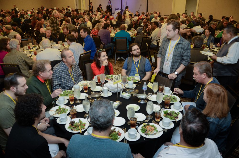 Fervor Records Head of A&R, Jacob Nathan (standing) gets ready to join a table full of TAXI members during the Mentor Lunch at the Road Rally.