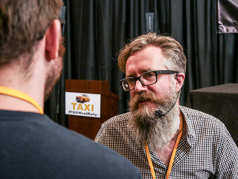 Music Supervisor Karl Richter gives his full attention to TAXI member Mark Himley. We’re not 100% sure that’s actually Mark, but we think we recognize his ear lobe.