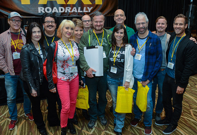 Matt Hirt (center, green short, big smile) was surrounded by his “fan club” of long time TAXI friends after he was honored with the John Braheny Genesis award at the 2018 Road Rally.