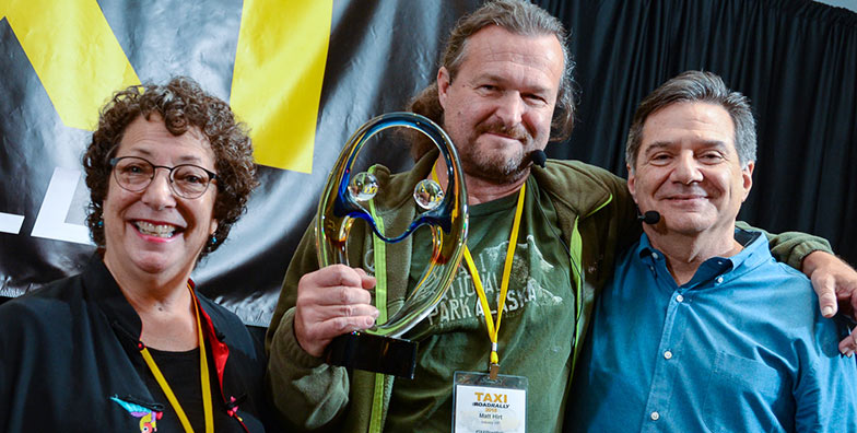 Successful TAXI member Matt Hirt is flanked by JoAnn Braheny and Michael Laskow as Hirt receives his John Braheny Genesis award.