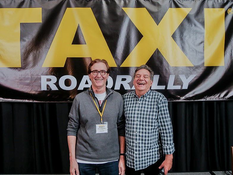 No matter how hard he tried, TAXI’s Michael Laskow couldn’t match Dean Krippaehne’s considerable height for this shot. Standing on his tippy toes didn’t work, but it got a good laugh!