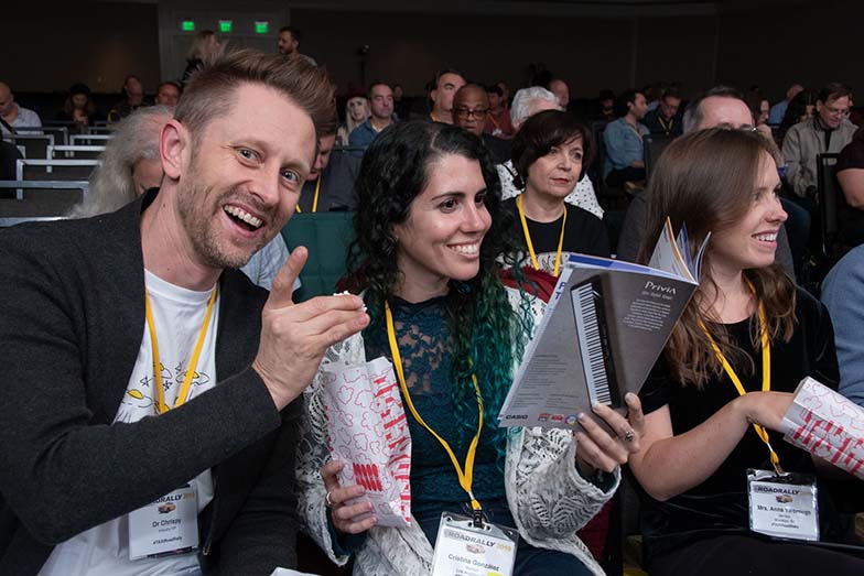 JTAXI Members Dr. Chrispy, Cristina González, and Anna Yarbrough enjoy the popcorn we gave the audience during one of the evening sessions in the Grand Ballroom. 