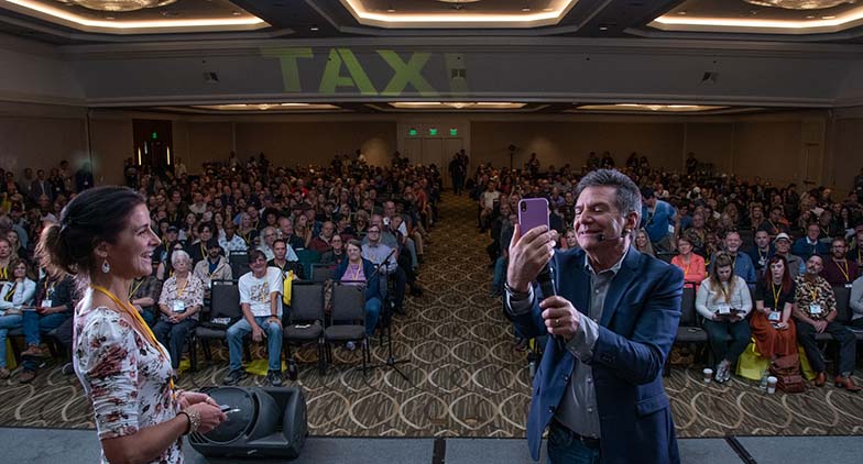 TAXI member Ragani Buegel let Michael Laskow use her phone to FaceTime with long-time member Matt Hirt, who now lives in Switzerland and couldn’t be at the Rally. Matt got to say “hello” to his many friends in the audience. It was almost as good as being there, at least for a couple of minutes.