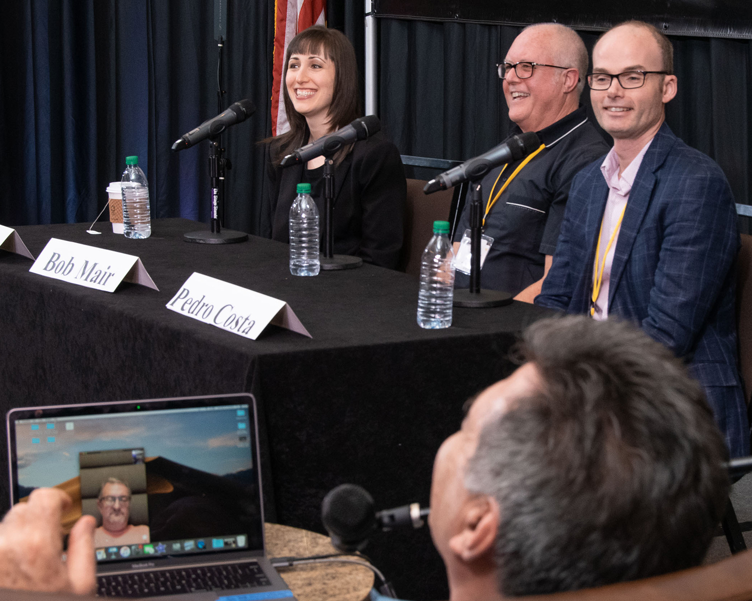 Panelist (l to r) Erin Jacobson, Bob Mair, Pedro Costa, and Michael Eames (on Michael Laskow's laptop) enjoy a light moment during their panel at the TAXI Road Rally.