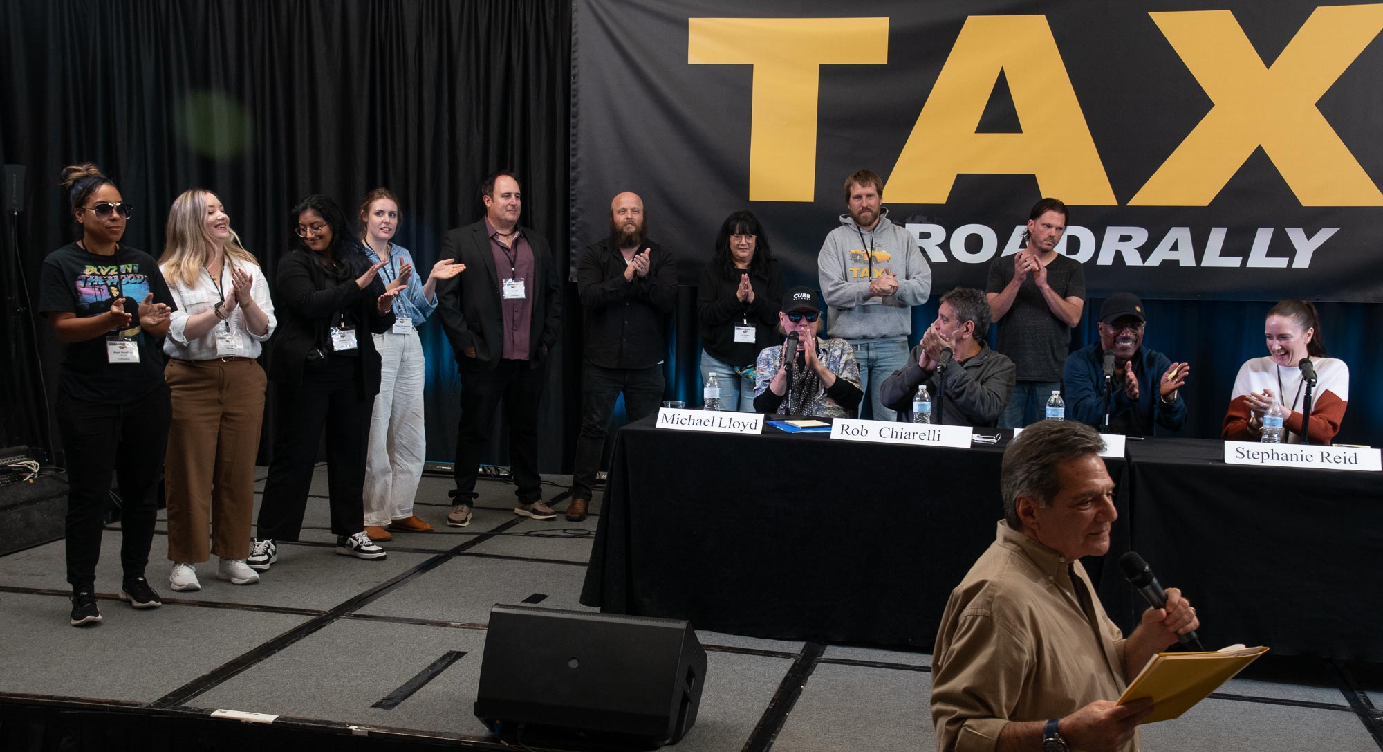 The TAXI staff gets ready to take a well-deserved bow at the end of the 2023 Road Rally. They are (from left to right); Angel Maradiaga, Ariana Cubillos Voegler, Ashmita Deo, Briagha Abrahamson, Craig Pilo, Eric Anderson, Liz Cohen, Matt Hutchison, and Tom Stillwagon.