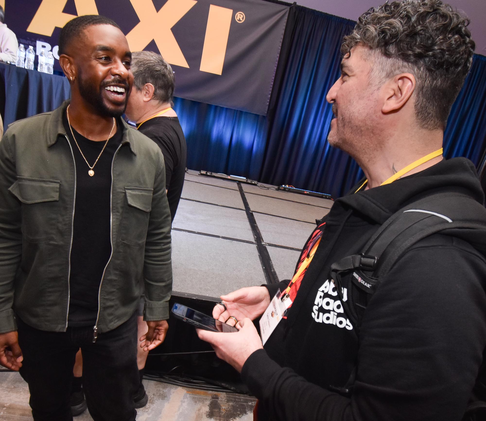 Hit Songwriter/Producer, Zaire Koalo, appears to be enjoying some conversation with a TAXI member.
