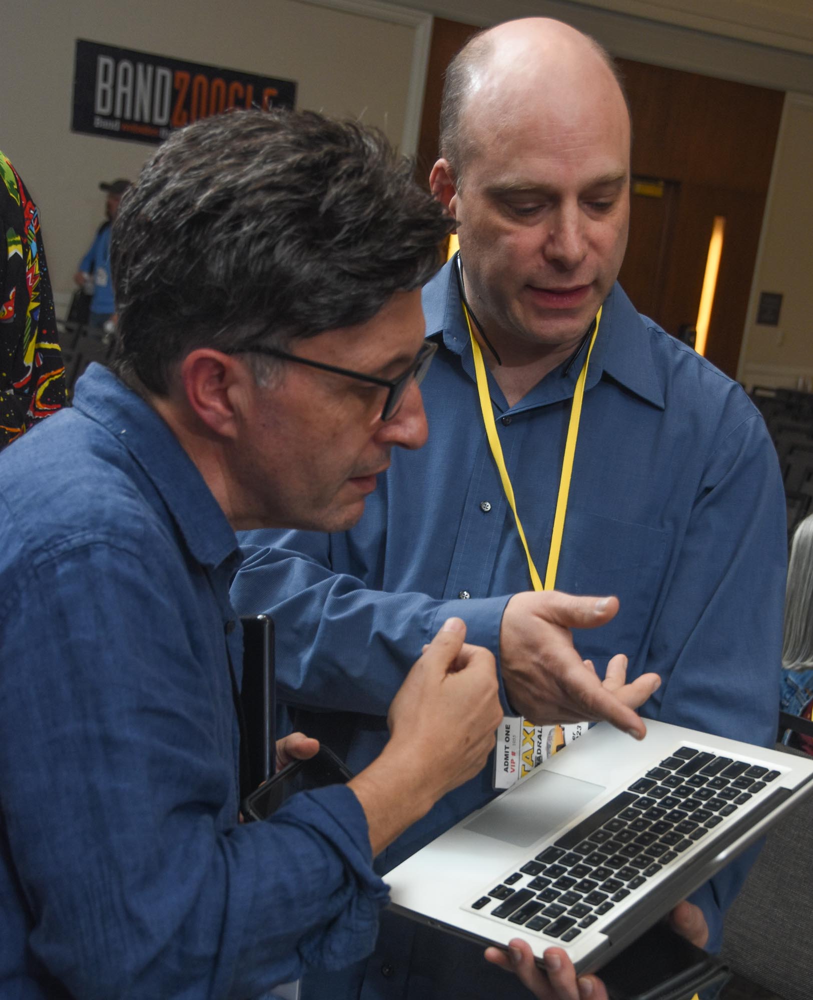 Composer, Adonis Aletras discusses film scoring with a member whose name on his badge we can almost see.