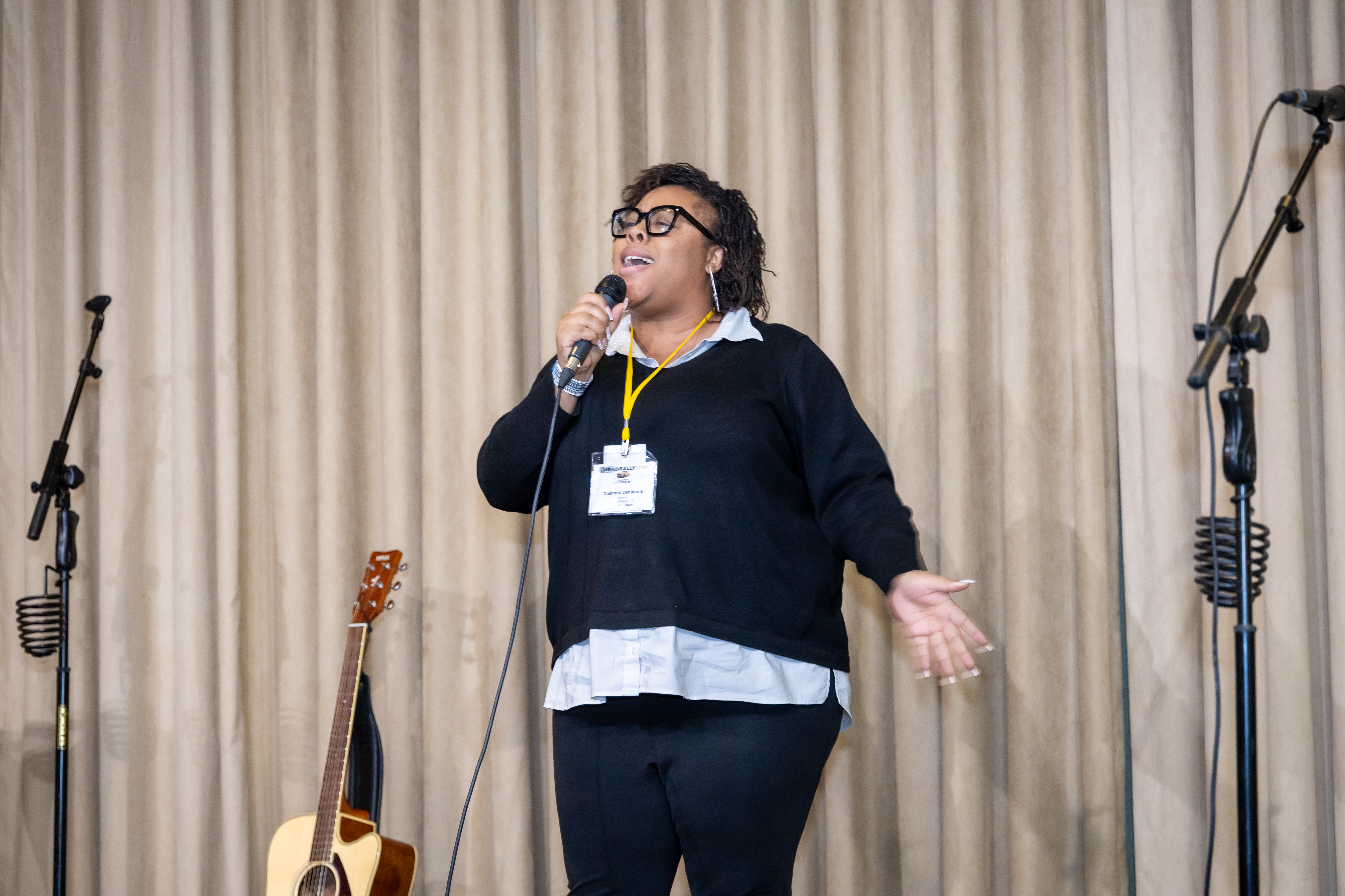 Diamond Densmore belts out one of her songs at the Open Mic.