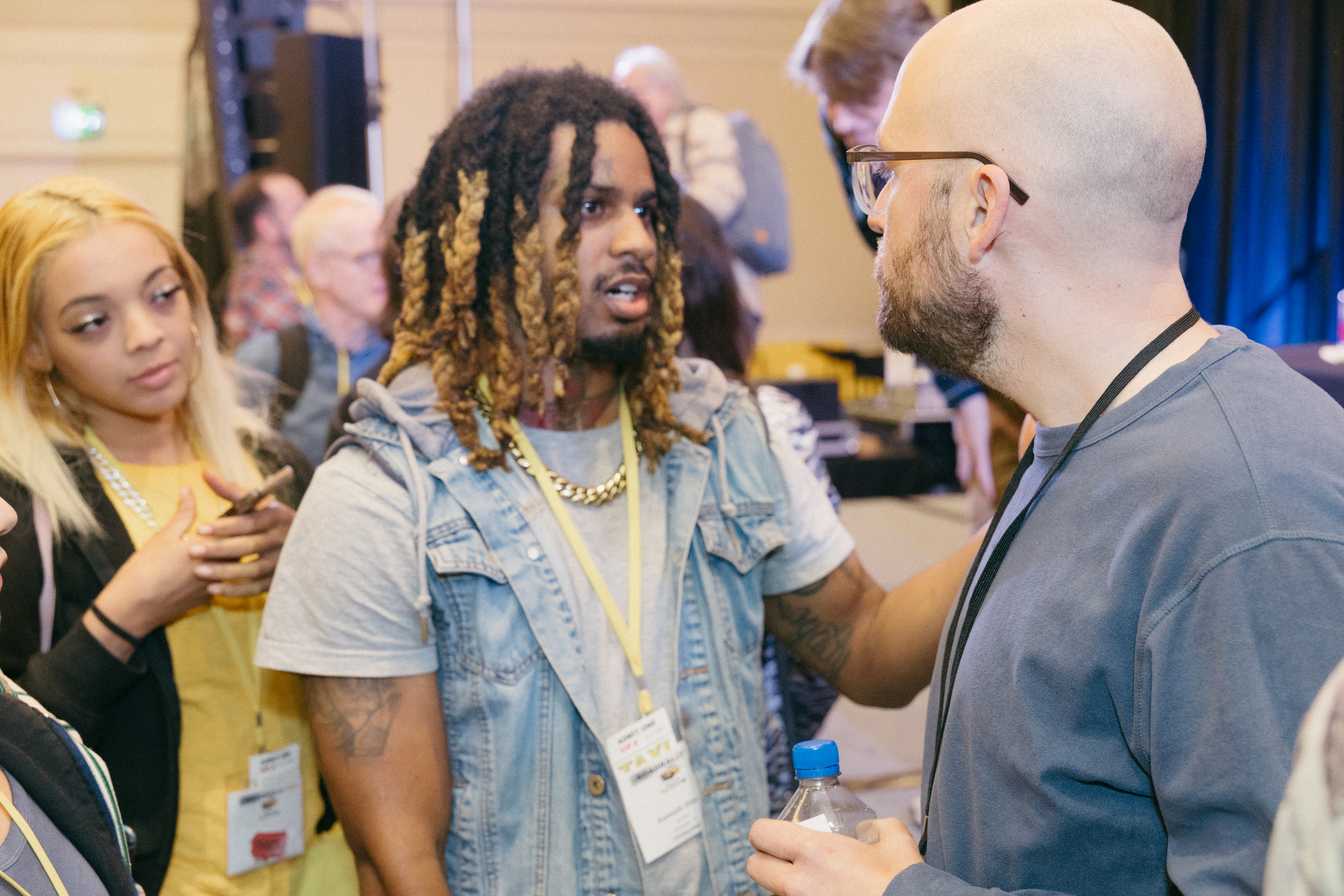 Music licensing executive Dan Waldkirch (right) chats with a couple of TAXI members we can’t identify because their badges are blurry—sorry!