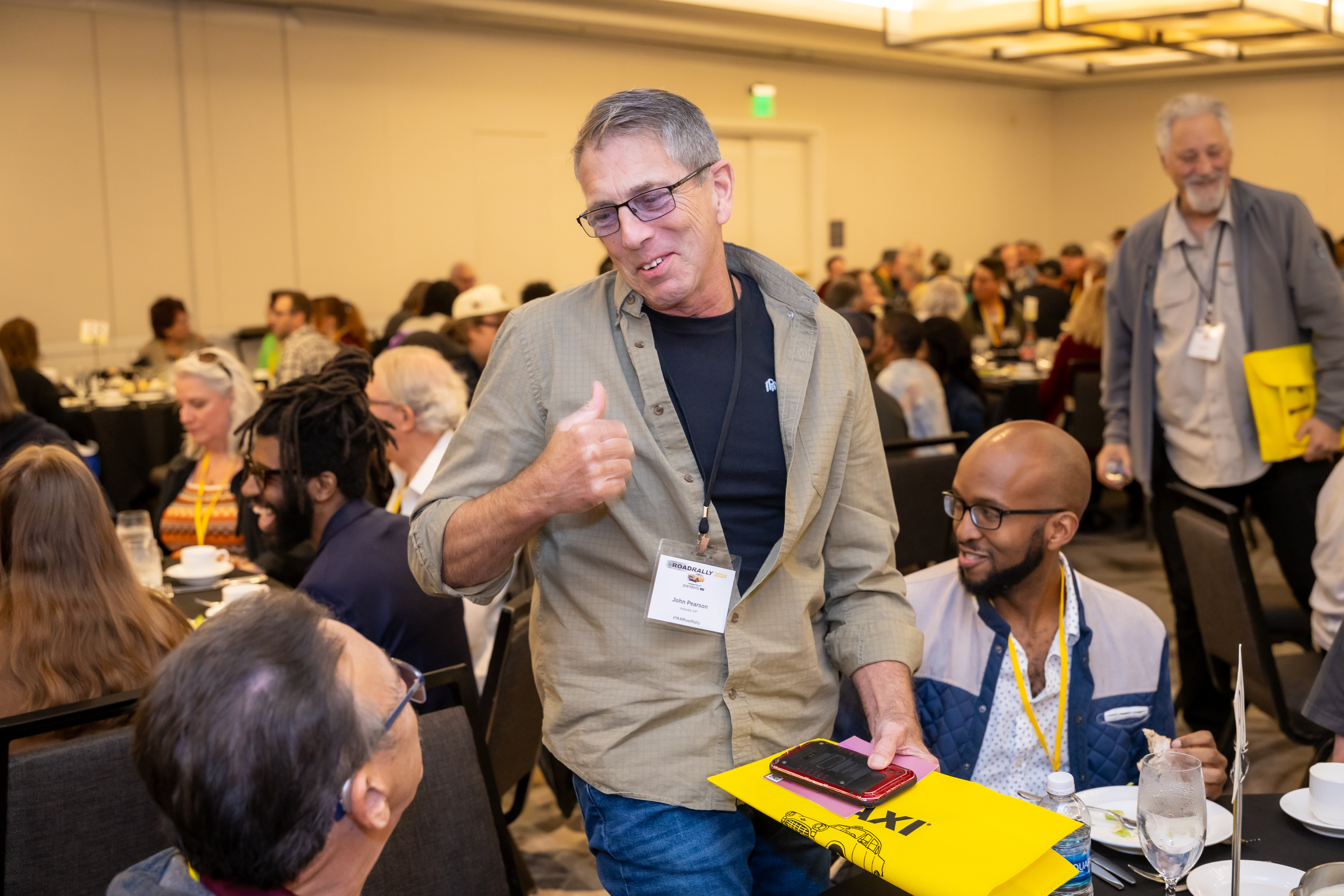 Successful TAXI member, songwriter, and producer John Pearson leaves one table full of happy mentees for another during the mentor rotation at the Eat & Greet Luncheon.