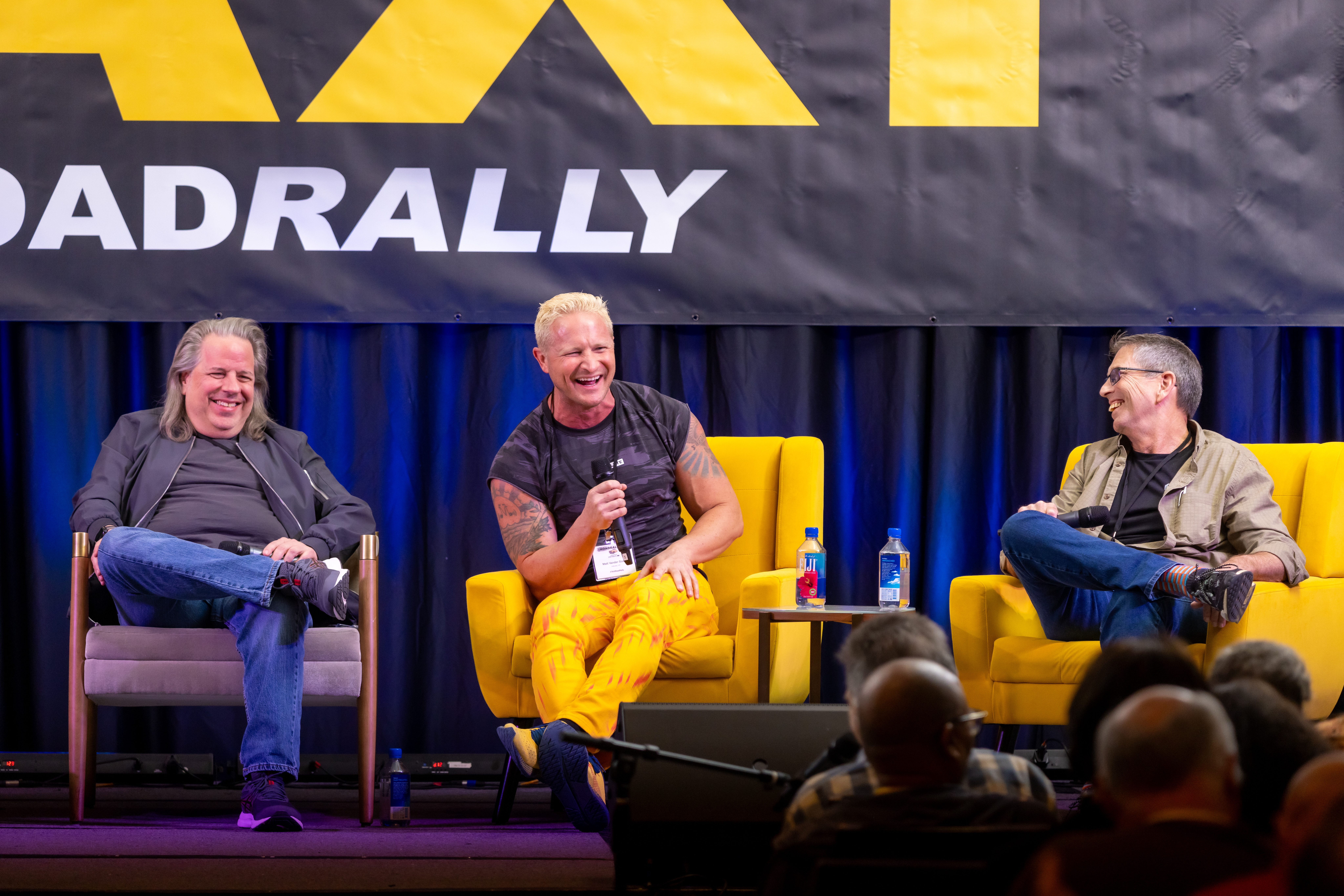 Matt Vander Boegh (yellow pants) cracks up his fellow panelists, Greg Carrozza (left) and John Pearson (right), along with the entire ballroom audience